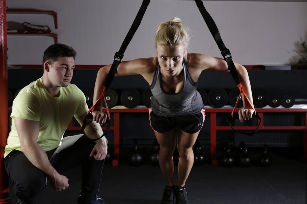 A Women Training in the gym with her coach