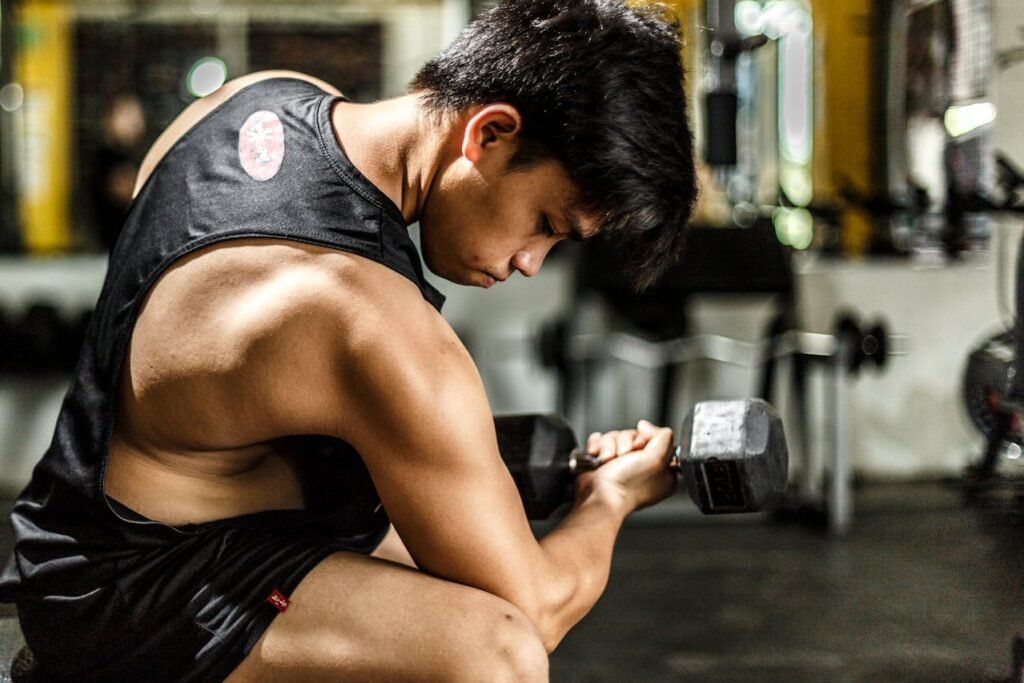 A boy doing dumbbell curl